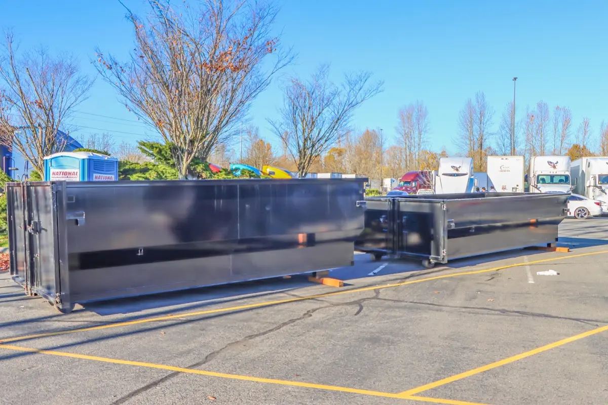 Professional dumpster rental service with roll-off container on residential driveway in Havelock